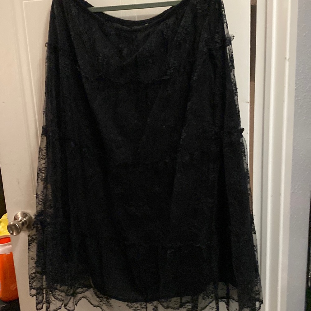 Black lace or black lining skirt. Really classy.